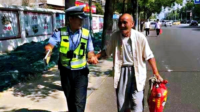 扶老人過(guò)馬路 執(zhí)勤民警平凡舉動(dòng)暖人心